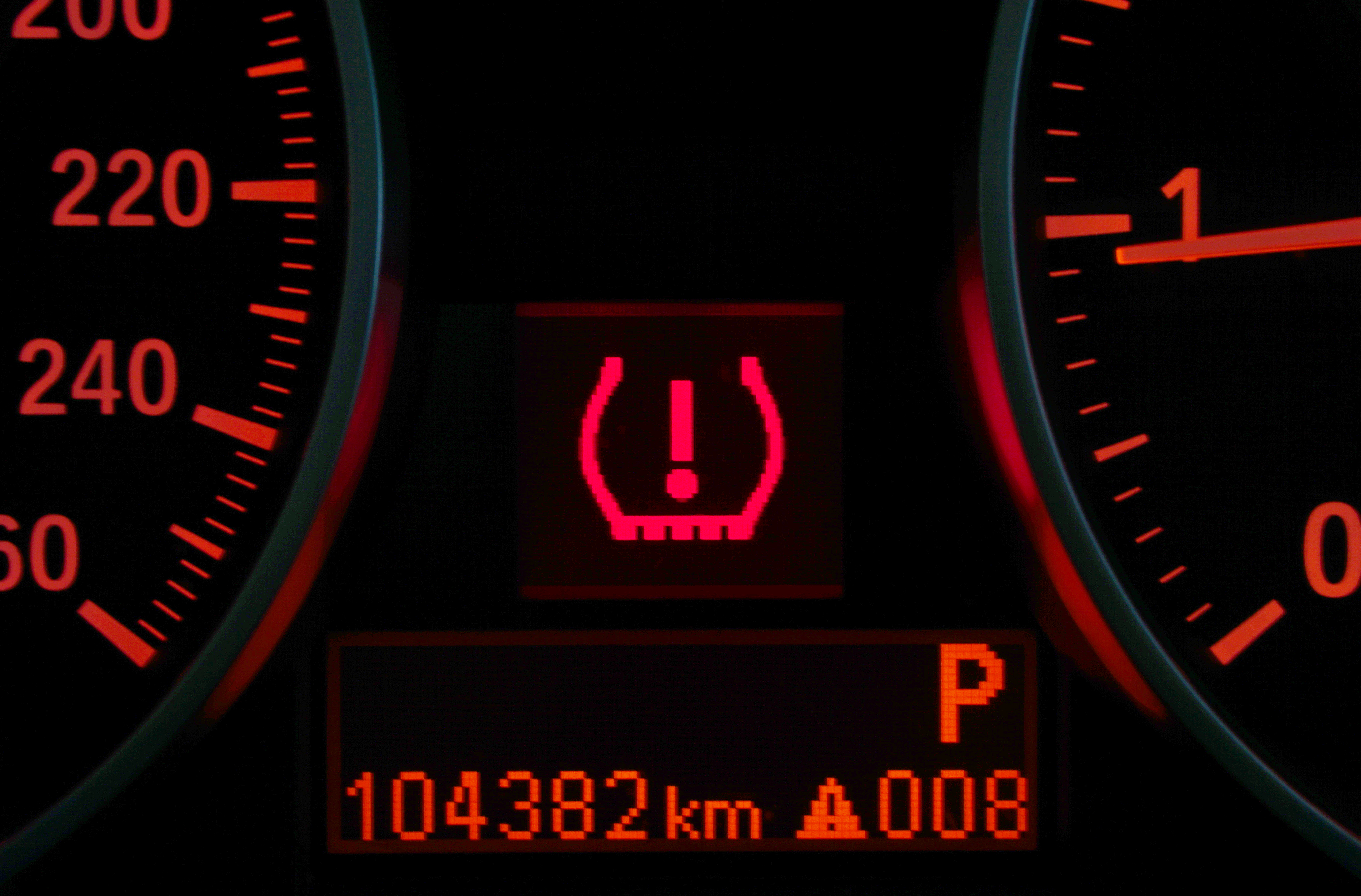 a picture of a dashboard with a tire pressure monitoring system light on